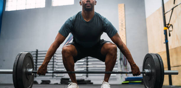 the full length of a man exercising in a gym