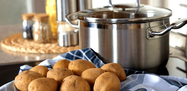whole potatoes and a big pot nearby on the counter