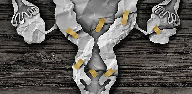 uterus surgery concept, ovaries, and fallopian tubes as crumpled paper with tape shaped as a female reproductive system